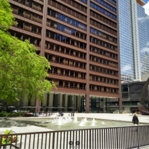 Urban plaza with fountain and modern architecture.