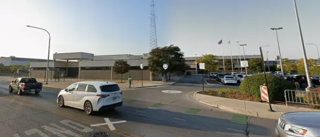 Traffic circle in front of a large building.